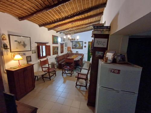 a kitchen and dining room with a table and a refrigerator at La Arcadia in Tafí del Valle
