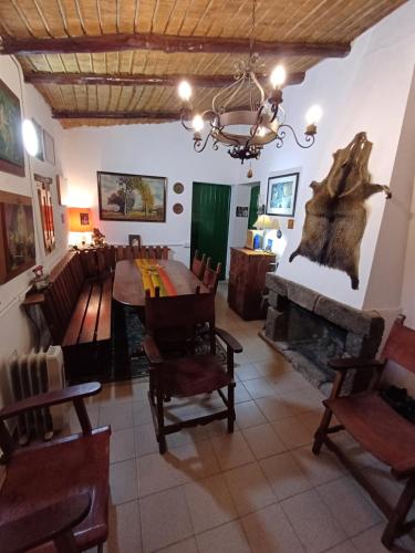 a dining room with a table and a fireplace at La Arcadia in Tafí del Valle
