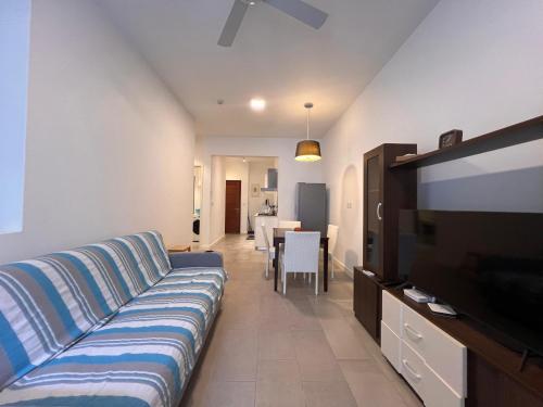 a living room with a couch and a flat screen tv at Ebene Square apartment in Trianon