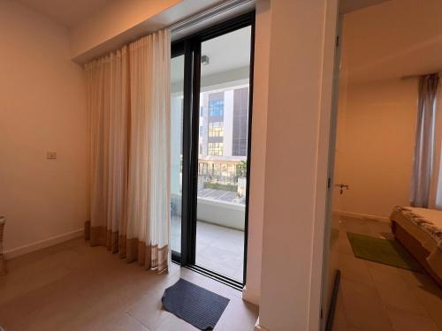 a room with a large glass door with a window at Ebene Square apartment in Trianon