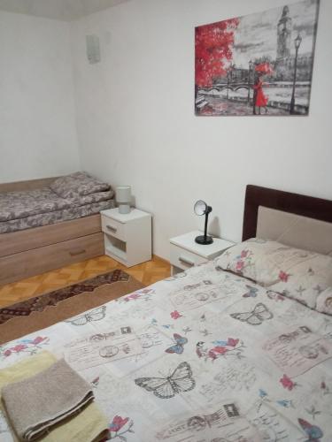 a bedroom with a bed with a bedspread with butterflies on it at Vila Viktori in Pirot