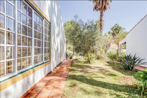 an exterior view of a house with windows and grass at Casa da Falésia in Melides