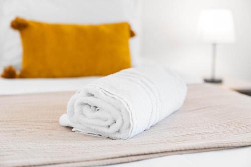a pile of white towels sitting on a bed at 2 Bedroom House - Garden & Parking 2GM - Wifi in Birmingham