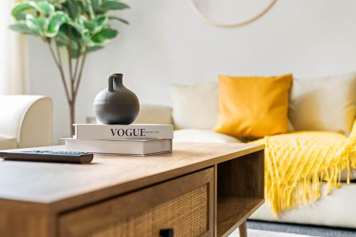 a living room with a table with a vase on it at 2 Bedroom House - Garden & Parking 2GM - Wifi in Birmingham