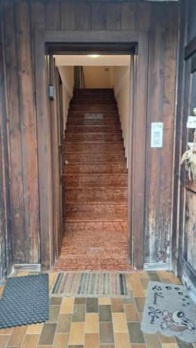 a hallway with stairs in an old building at Attico con vista sulle Dolomiti in Calalzo