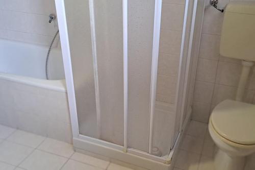 a bathroom with a shower and a toilet at Attico con vista sulle Dolomiti in Calalzo