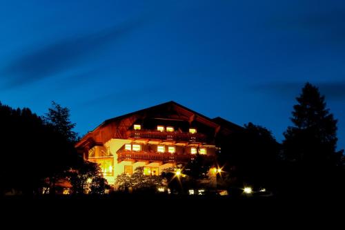 a large house with lights on at night at Ladestatthof in Neustift im Stubaital
