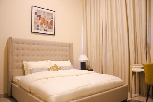 a bedroom with a large bed with a white bedspread at Studio Apartment in Abudhabi Zc in Abu Dhabi
