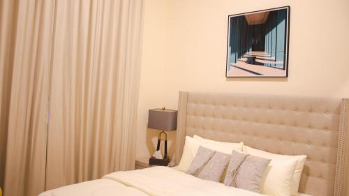 a bedroom with a bed with white sheets and pillows at Studio Apartment in Abudhabi Zc in Abu Dhabi