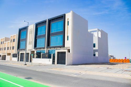 a building with large windows on the side of a street at Studio Apartment in Abudhabi Zc in Abu Dhabi