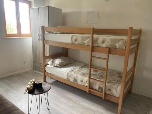 a room with two bunk beds and a table at Salah in Neum