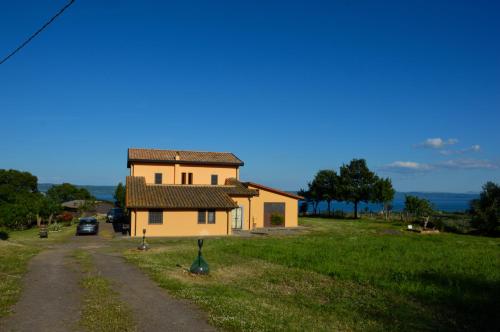 a small house in a field next to a road at La Fraschetta in Bolsena
