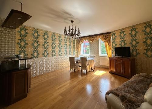 een woonkamer met een tafel en stoelen en een eetkamer bij Emerald Suite in Praag