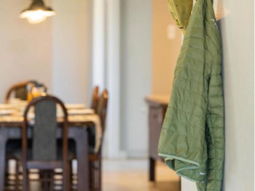 a dining room with a table and a green umbrella at Flying Ostrich Guesthouse & Self-catering Accommodation in Mariental