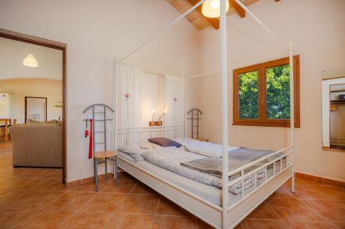 a bedroom with a canopy bed in a room at Buena Vista in Montuiri