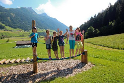 a group of children standing on a ropegame at Ladestatthof in Neustift im Stubaital