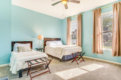 a bedroom with two beds and a ceiling fan at 1 Mi to Dtown and Lucas Oil Stadium Home in Indy! in Indianapolis