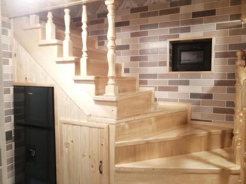 a staircase in a brick wall with a fireplace at Eldeniz Nuxa House in Sheki