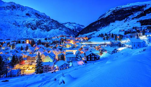 a small town in the snow at night at *TOP* moderne Wohnung im Herzen von Andermatt in Andermatt