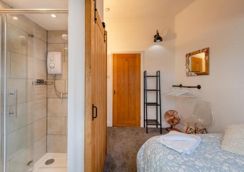 a bedroom with a shower and a bed and a bathroom at Little Seacroft in Bucks Mills