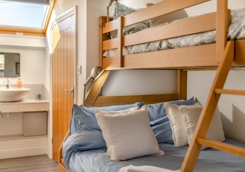 a bedroom with a bunk bed and a sink at Little Seacroft in Bucks Mills