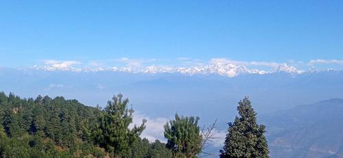 a mountain range with snow capped mountains in the distance at Everest Home Stay Temal Kalimati Tower in Thapathali