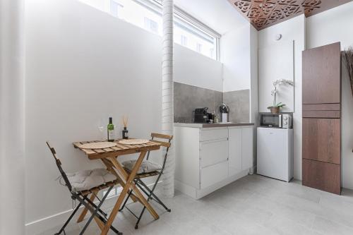 une cuisine avec une table et des chaises dans une pièce dans l'établissement MyKeypers - Lovely Studio with Jacuzzi Paris, à Paris