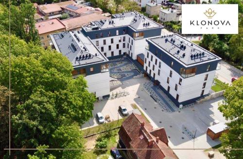 an aerial view of a large white building at Apartamenty Klonova Park in Olecko