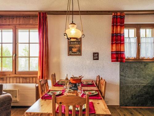 a dining room with a wooden table and chairs at Apartment Chamois AZ1 by Interhome in Agettes