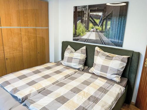 a bedroom with a bed with a checkered blanket at Apartment Kersten by Interhome in Essen