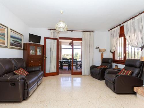 a living room with two leather couches and a table at Holiday Home Villa Paloma by Interhome in Peñíscola