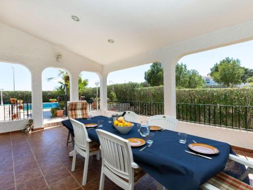 a dining room with a blue table and white chairs at Holiday Home Villa Paloma by Interhome in Peñíscola