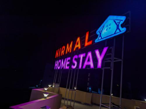 a neon sign that says miami home stay at Nirmal Luxury Rooms in Garudeshwar
