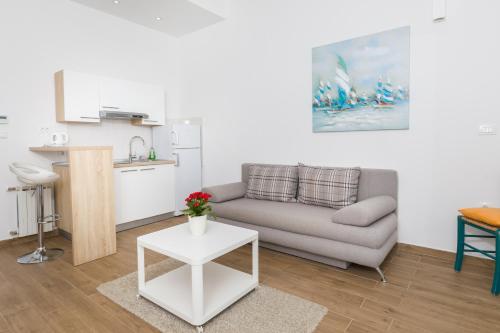 a living room with a couch and a table at Stella Mare Eco Boutique House in Zavala