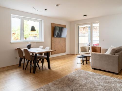 a living room with a table and a couch at Apartment be magic by Interhome in Mieming