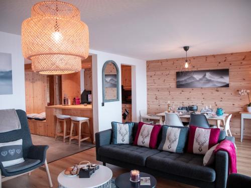 a living room with a couch and a table at Apartment Jade 22 by Interhome in Villars-sur-Ollon