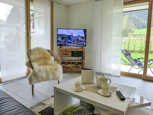 a living room with a chair and a coffee table at Apartment Bergluft by Interhome in Kandersteg