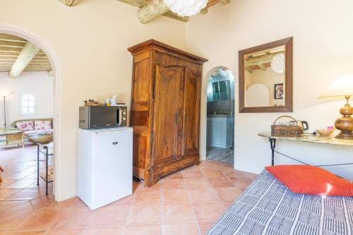 Elle comprend un salon avec un réfrigérateur et un four micro-ondes. dans l'établissement Orangerie, à Bonnieux