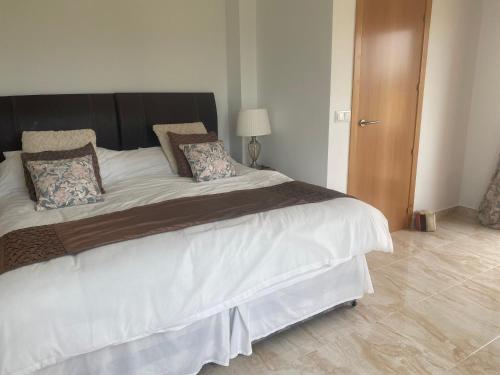 a bedroom with a large bed with white sheets and pillows at Mar Menor Golf Villa - Frontline Detached - Heated Pool in Torre-Pacheco