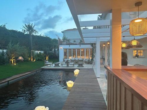 a house with a swimming pool in the backyard at VILLA LES PEUPLIERS in Royan