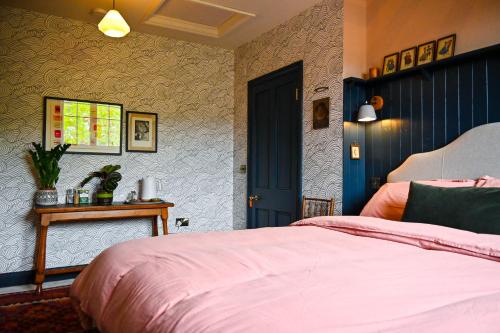 a bedroom with a bed and a blue door at The Dover Stop in Dover