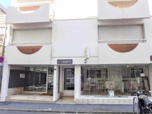 un magasin devant un bâtiment blanc avec fenêtres dans l'établissement Studio Saint Andrews-3 by Interhome, à Biarritz