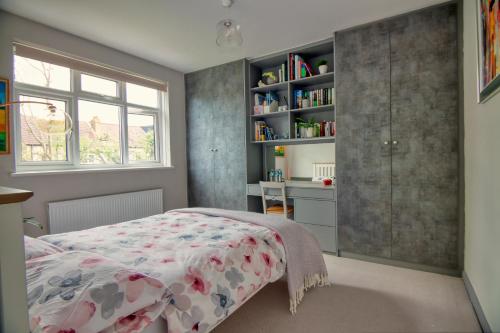 a bedroom with a bed and a book shelf at Spacious Double Room with Private Bathroom in Streatham Common, Southwest London in Streatham Vale