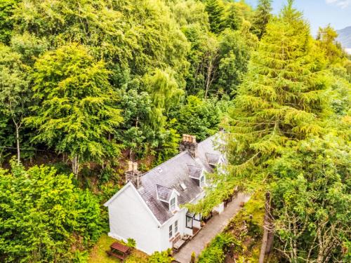 an aerial view of a house in the woods at Holiday Home Dancot by Interhome in Invermoriston