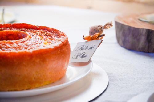 a piece of cake on a plate on a table at VELINN Hotel Fazenda Fonte das Hortênsias in Santo Antônio do Pinhal
