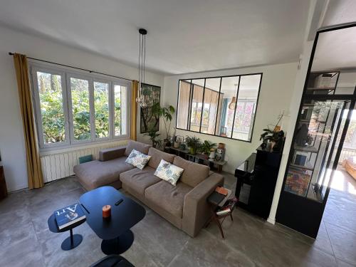 un salon avec un canapé et une table dans l'établissement Maison nature proche centre ville, à Aix-en-Provence
