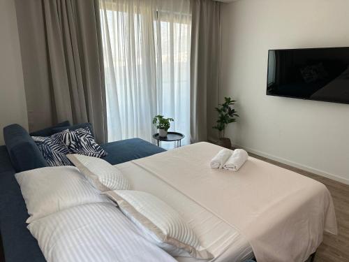 En eller flere senge i et værelse på Our Lady Aparthotel Amfora