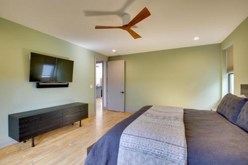 a bedroom with a bed and a flat screen tv at Sprawling Kaufman Home with On-Site Lake and Fire Pit in Kaufman