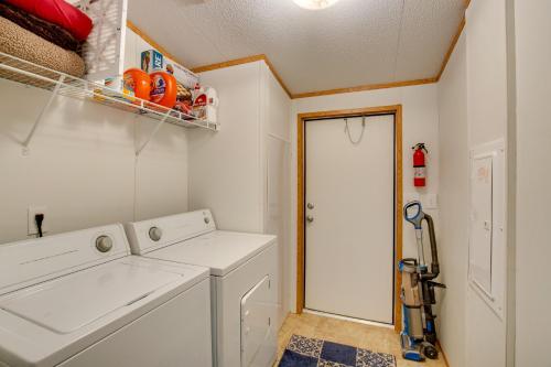 a laundry room with a white washing machine and a door at Sprawling Kaufman Home with On-Site Lake and Fire Pit in Kaufman