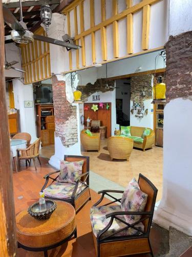 a living room with two chairs and a table at Hotel Nueva Granada in Santa Marta